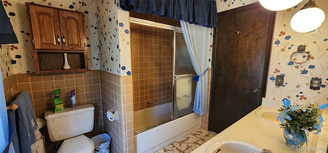 15480 Sherwood Ln, Fraser, MI 48026 - bathroom featuring wallpapered walls, enclosed tub / shower combo, double vanity, and tile walls