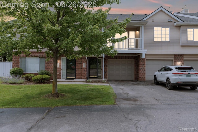 3343 Northpointe Blvd, Melvindale, MI 48122 - view of front of home featuring an attached garage, brick siding, driveway, a yard, and a balcony