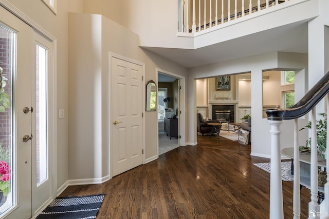 7145 S Valley Cir, Lambertville, MI 48144 - entrance foyer featuring a glass covered fireplace, plenty of natural light, dark wood-style floors, and a high ceiling