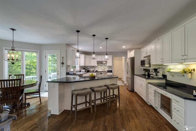 7145 S Valley Cir, Lambertville, MI 48144 - kitchen with stainless steel appliances, dark countertops, tasteful backsplash, white cabinets, and dark wood-type flooring