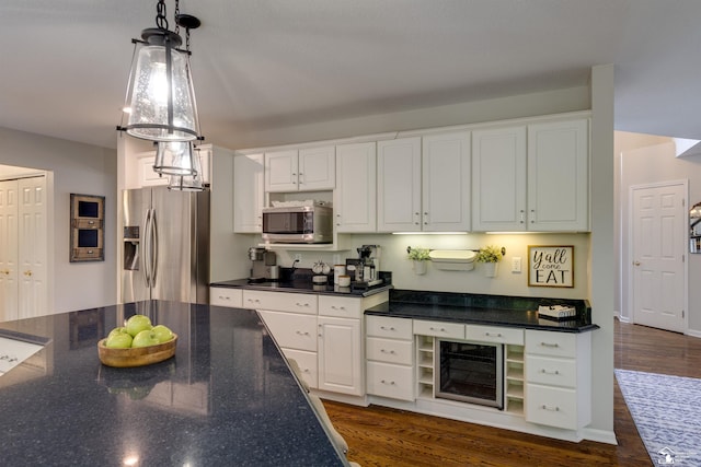 7145 S Valley Cir, Lambertville, MI 48144 - kitchen featuring appliances with stainless steel finishes, wine cooler, white cabinets, hanging light fixtures, and dark wood-type flooring
