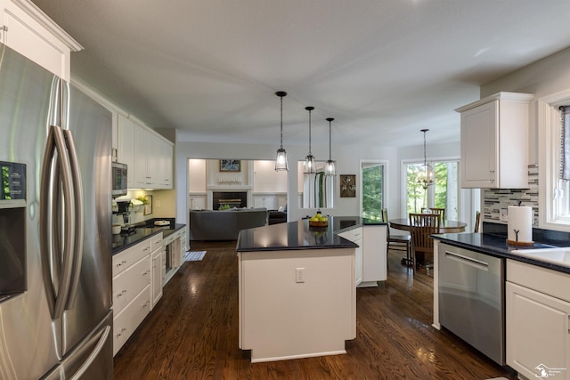7145 S Valley Cir, Lambertville, MI 48144 - kitchen with appliances with stainless steel finishes, a center island, dark countertops, and white cabinets