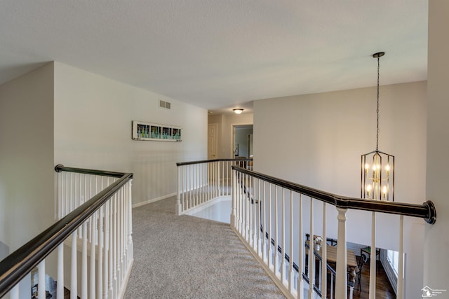 7145 S Valley Cir, Lambertville, MI 48144 - hallway featuring an upstairs landing, a chandelier, and carpet flooring