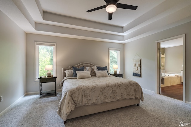 7145 S Valley Cir, Lambertville, MI 48144 - carpeted bedroom featuring a tray ceiling, ensuite bathroom, and a ceiling fan