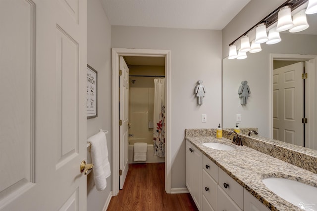 7145 S Valley Cir, Lambertville, MI 48144 - full bathroom with double vanity, wood finished floors, and shower / bath combo