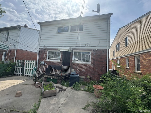 16740 Woodingham Dr, Detroit, MI 48221 - rear view of house with a patio area and brick siding