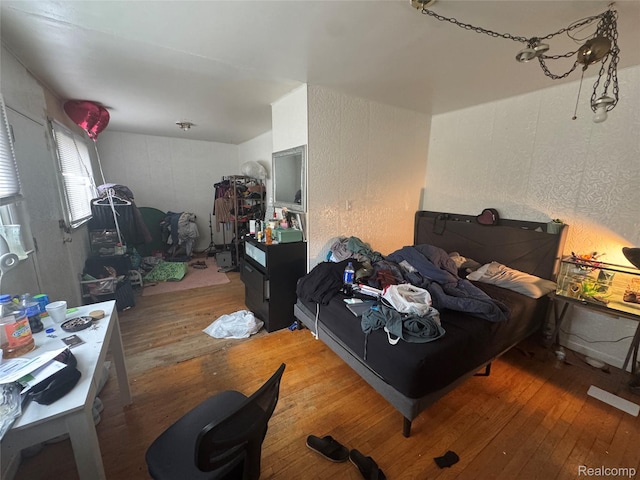 16740 Woodingham Dr, Detroit, MI 48221 - bedroom with wood-type flooring and a textured wall