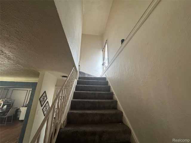 16740 Woodingham Dr, Detroit, MI 48221 - stairway featuring a textured wall, a textured ceiling, and wood finished floors