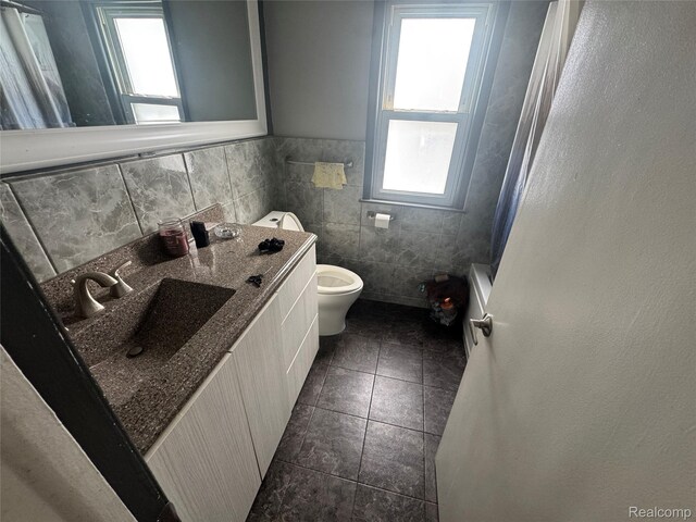 16740 Woodingham Dr, Detroit, MI 48221 - bathroom with plenty of natural light, tile patterned floors, tile walls, vanity, and a shower with shower curtain