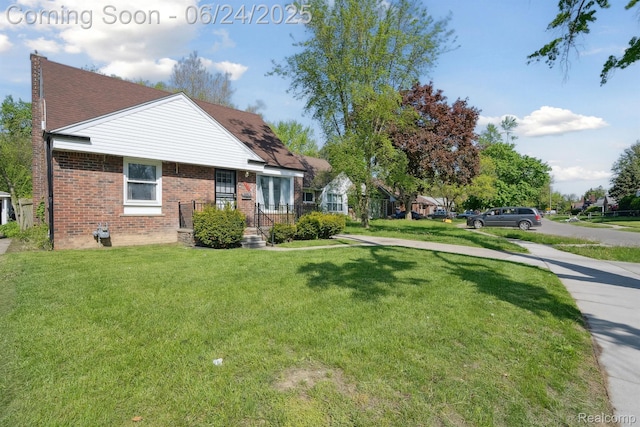 18625 Codding St, Detroit, MI 48219 - view of home's exterior featuring a lawn, brick siding, and roof with shingles