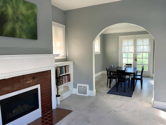 3254 W W Philadelphia St, Detroit, MI 48206 - dining room featuring arched walkways, a fireplace, and carpet