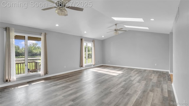5050 Burton Rd, Capac, MI 48014 - empty room featuring a ceiling fan, a skylight, vaulted ceiling, wood finished floors, and recessed lighting