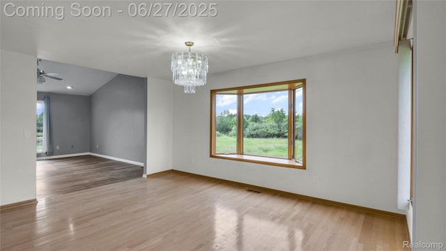 5050 Burton Rd, Capac, MI 48014 - spare room with a chandelier, wood finished floors, and ceiling fan
