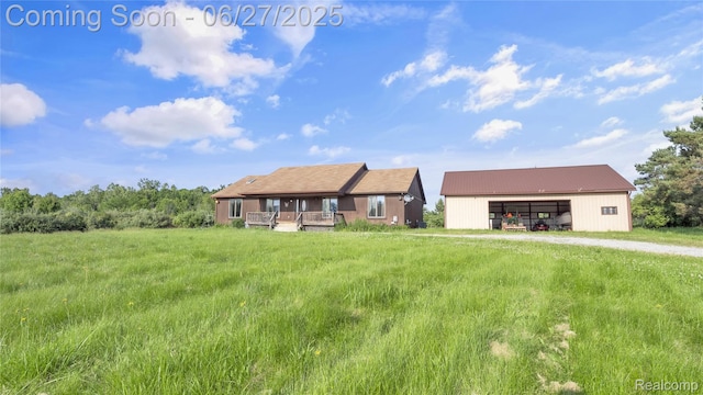 5050 Burton Rd, Capac, MI 48014 - view of front of property featuring a pole building, a garage, an outbuilding, and a metal roof