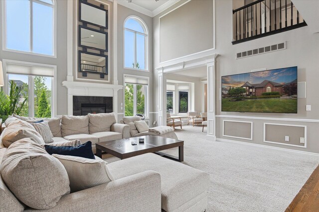 46746 Merion Cir, Northville, MI 48168 - living room with a high ceiling, crown molding, and a tiled fireplace