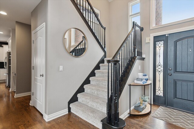 46746 Merion Cir, Northville, MI 48168 - foyer entrance featuring stairs, dark wood-style flooring, recessed lighting, and a high ceiling