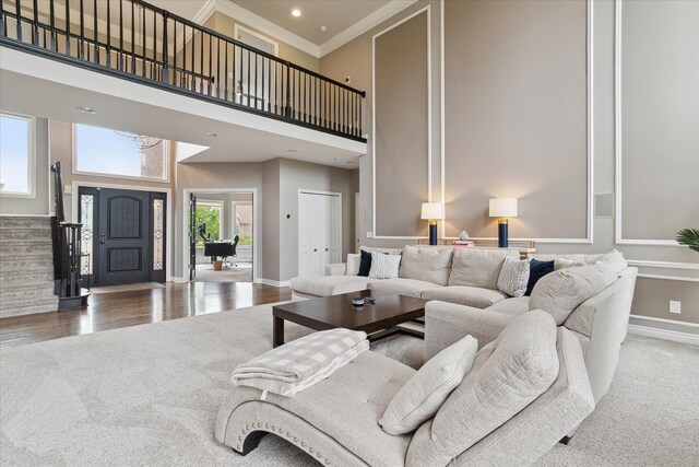 46746 Merion Cir, Northville, MI 48168 - carpeted living room with stairs, crown molding, a high ceiling, and wood finished floors