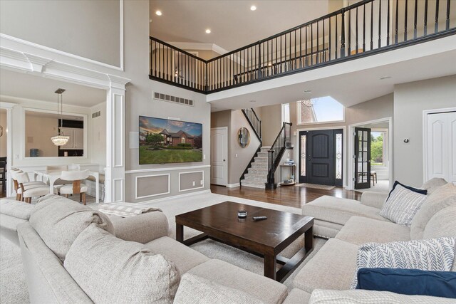 46746 Merion Cir, Northville, MI 48168 - living area with a towering ceiling, stairs, and recessed lighting