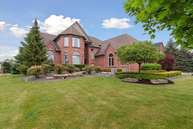 46746 Merion Cir, Northville, MI 48168 - view of front of house featuring brick siding, a front lawn, and a shingled roof