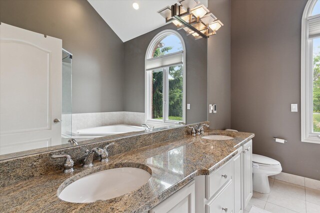 46746 Merion Cir, Northville, MI 48168 - full bathroom featuring tile patterned floors, healthy amount of natural light, a bath, double vanity, and high vaulted ceiling