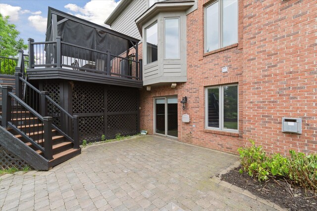 46746 Merion Cir, Northville, MI 48168 - rear view of property with brick siding, a deck, and a patio