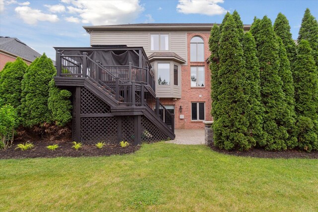 46746 Merion Cir, Northville, MI 48168 - rear view of house with stairs, a lawn, brick siding, and a deck