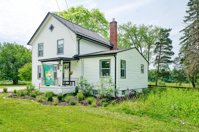 4151 Dexter Ann Arbor Rd, Ann Arbor, MI 48103 - view of front facade with a chimney, a front yard, and a shingled roof