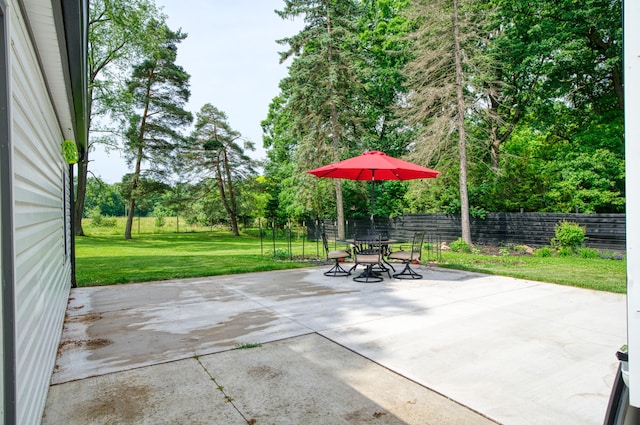 4151 Dexter Ann Arbor Rd, Ann Arbor, MI 48103 - fenced backyard featuring a patio area, outdoor dining area, and view of wooded area