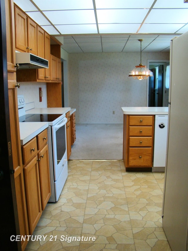 4215 S Wayside Dr, Saginaw, MI 48603 - kitchen featuring white appliances, under cabinet range hood, light countertops, brown cabinetry, and light colored carpet