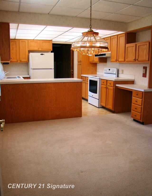 4215 S Wayside Dr, Saginaw, MI 48603 - kitchen featuring white appliances, a paneled ceiling, under cabinet range hood, a peninsula, and brown cabinets