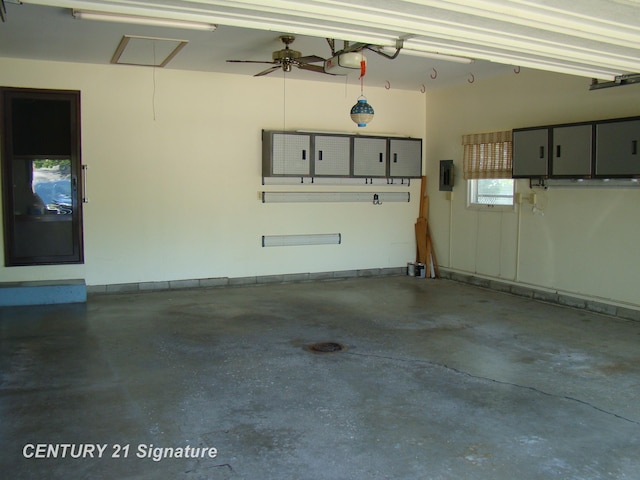 4215 S Wayside Dr, Saginaw, MI 48603 - garage with electric panel, ceiling fan, and a garage door opener