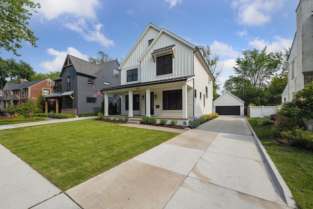 1053 Canterbury St, Birmingham, MI 48009 - modern farmhouse style home with board and batten siding, a porch, a detached garage, a front lawn, and an outbuilding