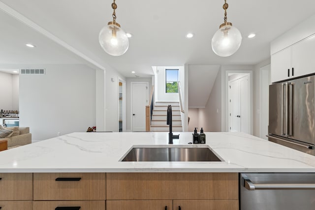 1053 Canterbury St, Birmingham, MI 48009 - kitchen with appliances with stainless steel finishes, open floor plan, decorative light fixtures, light stone counters, and recessed lighting