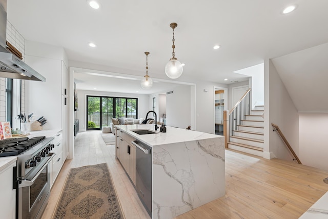 1053 Canterbury St, Birmingham, MI 48009 - kitchen featuring extractor fan, appliances with stainless steel finishes, modern cabinets, light wood finished floors, and recessed lighting