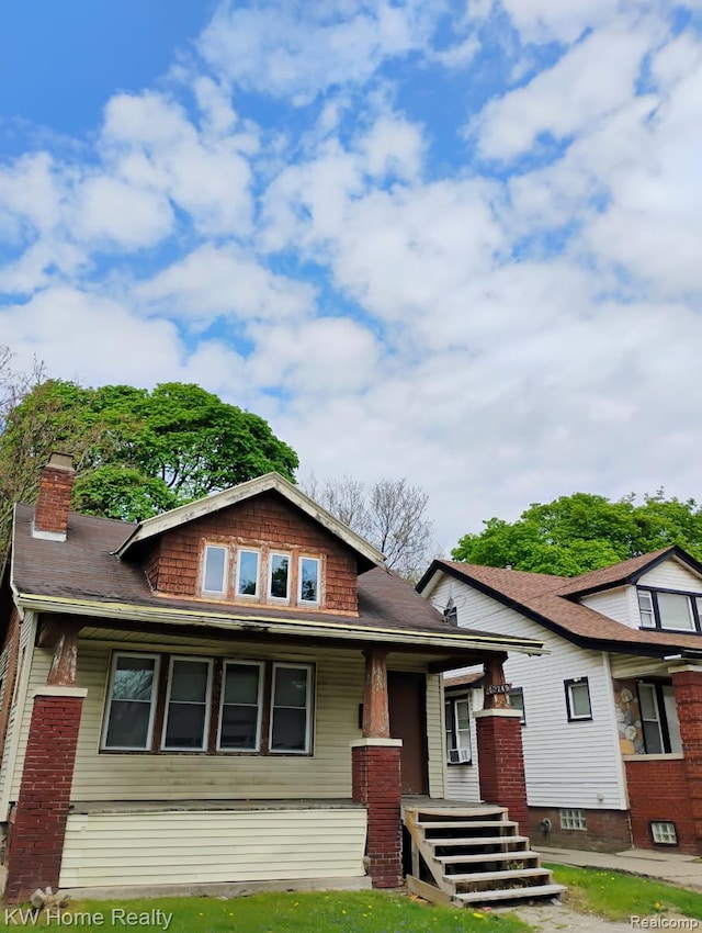 12749 Washburn St, Detroit, MI 48238 - view of front of house featuring covered porch, a chimney, and roof with shingles
