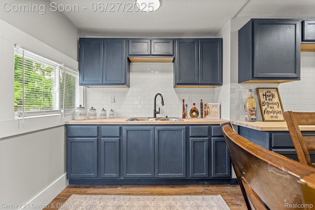 3917 Bewick St, Detroit, MI 48214 - kitchen with wood finished floors, backsplash, and blue cabinetry