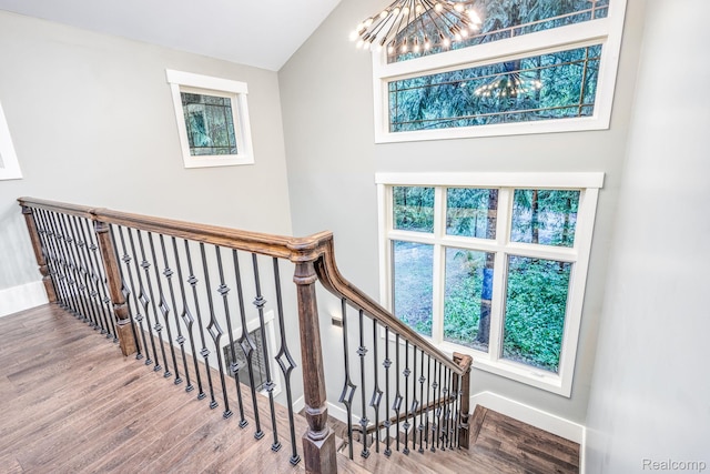 2685 Fry Rd, Highland, MI 48357 - stairs with a chandelier and wood finished floors