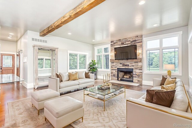 2685 Fry Rd, Highland, MI 48357 - living room featuring wood finished floors, a fireplace, recessed lighting, and beam ceiling