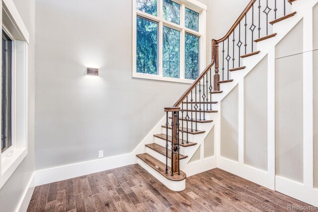 2685 Fry Rd, Highland, MI 48357 - stairway with wood finished floors