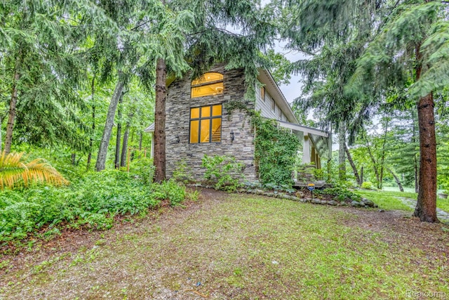 2685 Fry Rd, Highland, MI 48357 - view of side of home featuring stone siding