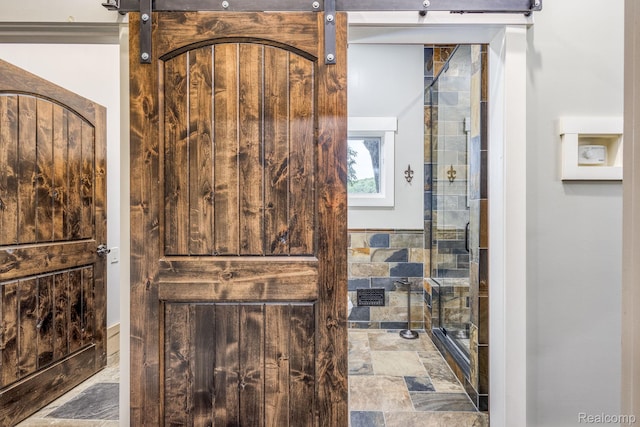 2685 Fry Rd, Highland, MI 48357 - bathroom featuring stone finish floors and a tile shower