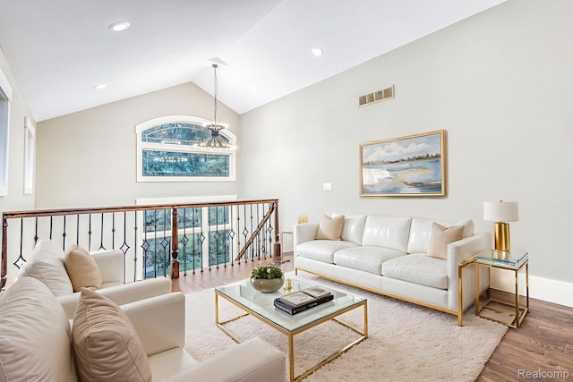 2685 Fry Rd, Highland, MI 48357 - living room featuring wood finished floors, vaulted ceiling, and recessed lighting
