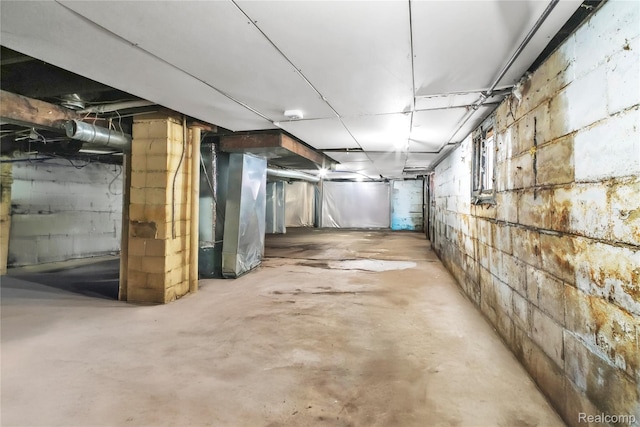 2211 Avon St, Saginaw, MI 48602 - unfinished basement featuring concrete block wall and heating unit