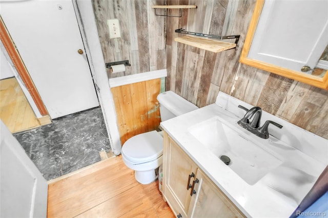 2211 Avon St, Saginaw, MI 48602 - bathroom with wooden walls, vanity, and wood finished floors