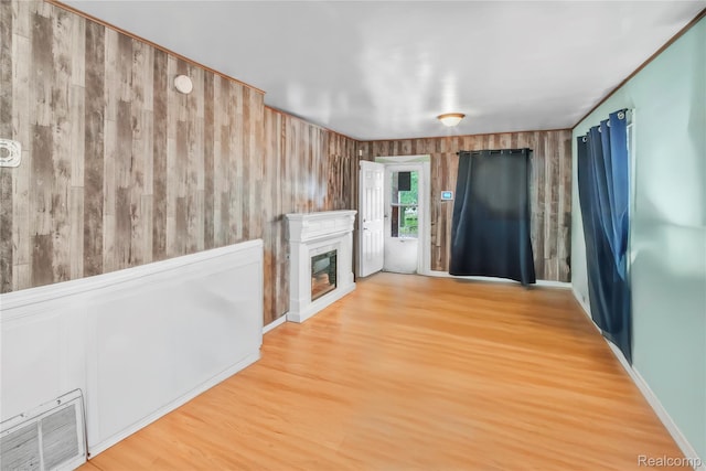 2211 Avon St, Saginaw, MI 48602 - unfurnished living room with wood finished floors and a glass covered fireplace