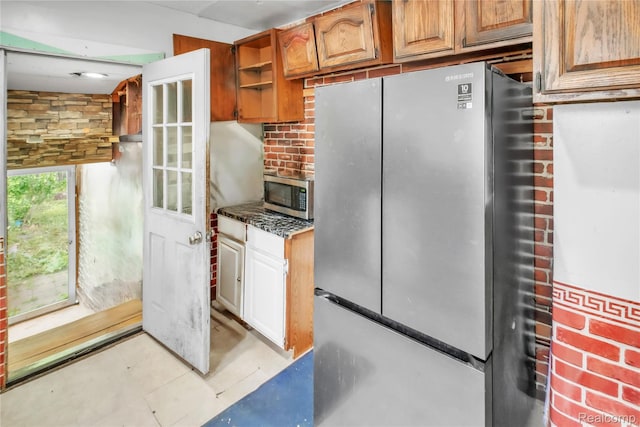 2211 Avon St, Saginaw, MI 48602 - kitchen with stainless steel appliances, open shelves, and brown cabinetry