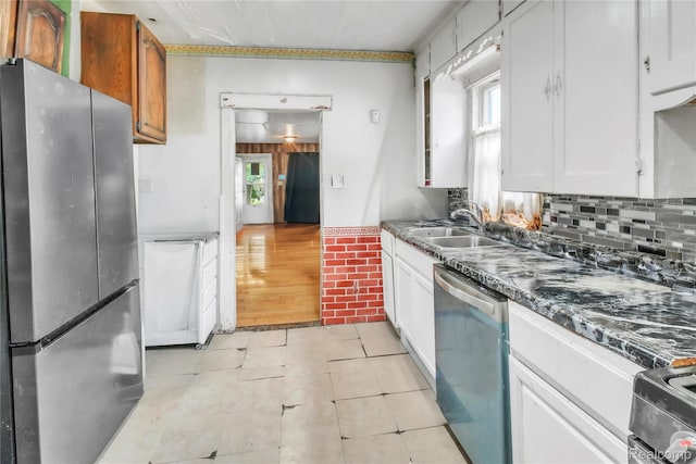 2211 Avon St, Saginaw, MI 48602 - kitchen with appliances with stainless steel finishes, healthy amount of natural light, light tile patterned flooring, and white cabinets