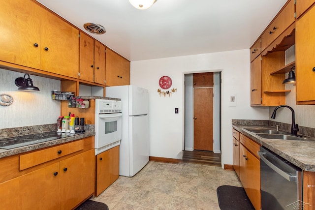 239 Heyn St, Saginaw, MI 48602 - kitchen with white appliances, brown cabinetry, and dark countertops