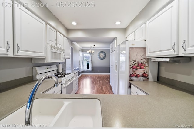 15653 Heather Ridge Trl, Clinton Township, MI 48038 - kitchen featuring white appliances, a chandelier, white cabinetry, recessed lighting, and dark wood-style flooring