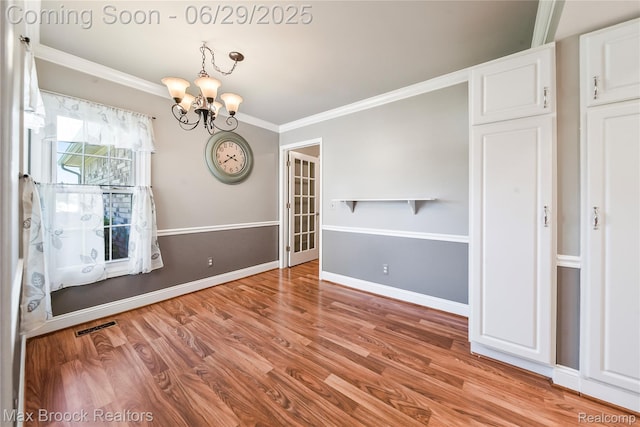15653 Heather Ridge Trl, Clinton Township, MI 48038 - empty room featuring a chandelier, crown molding, and light wood finished floors